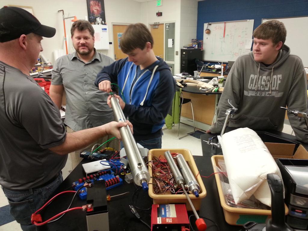 students and instructors working on a project together