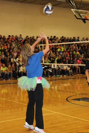 staff playing volleyball in a tutu