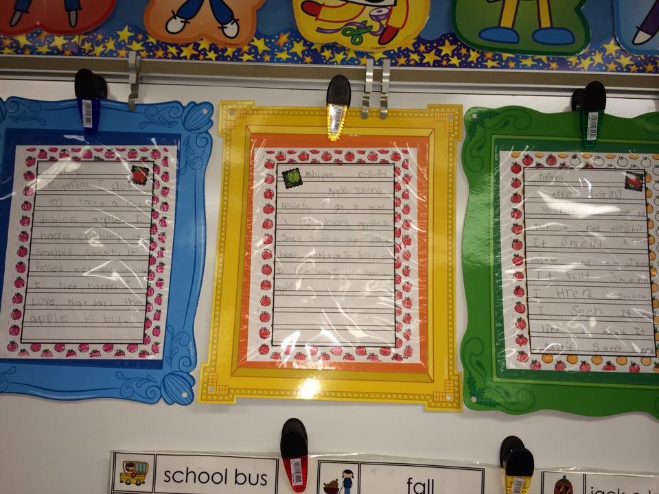 framed pages of children's writing about apples