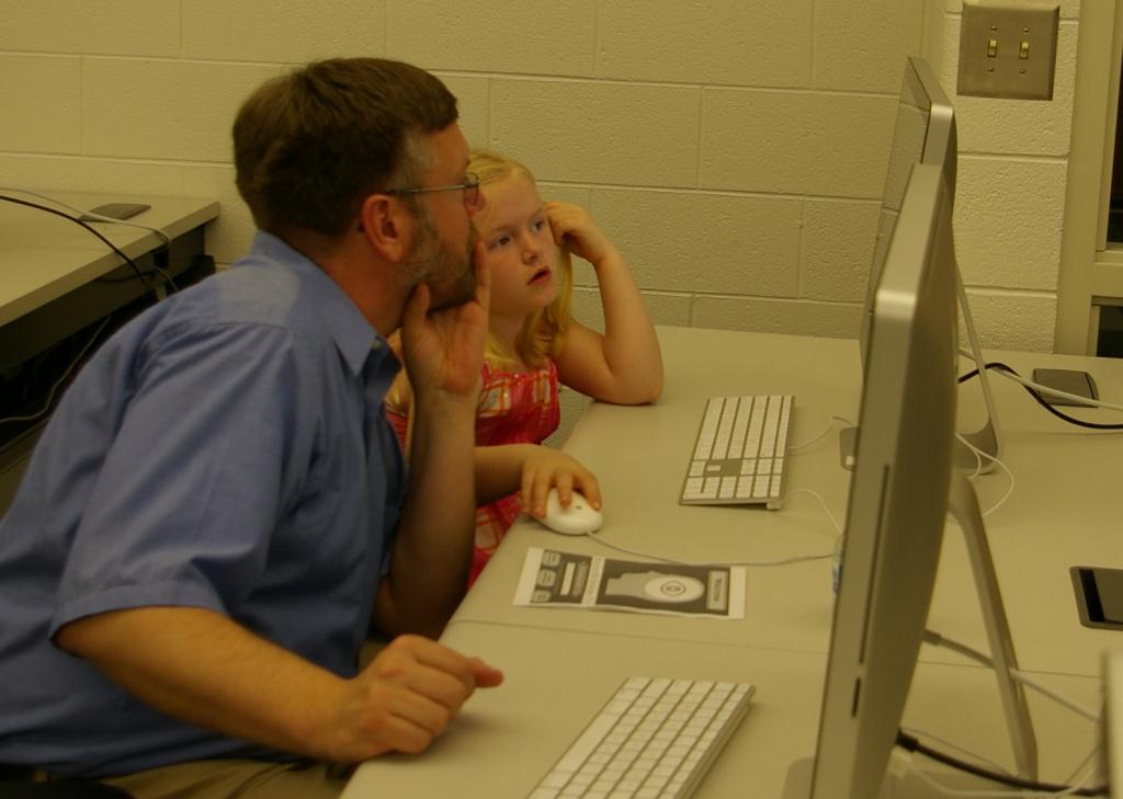 child and instructor at a computer